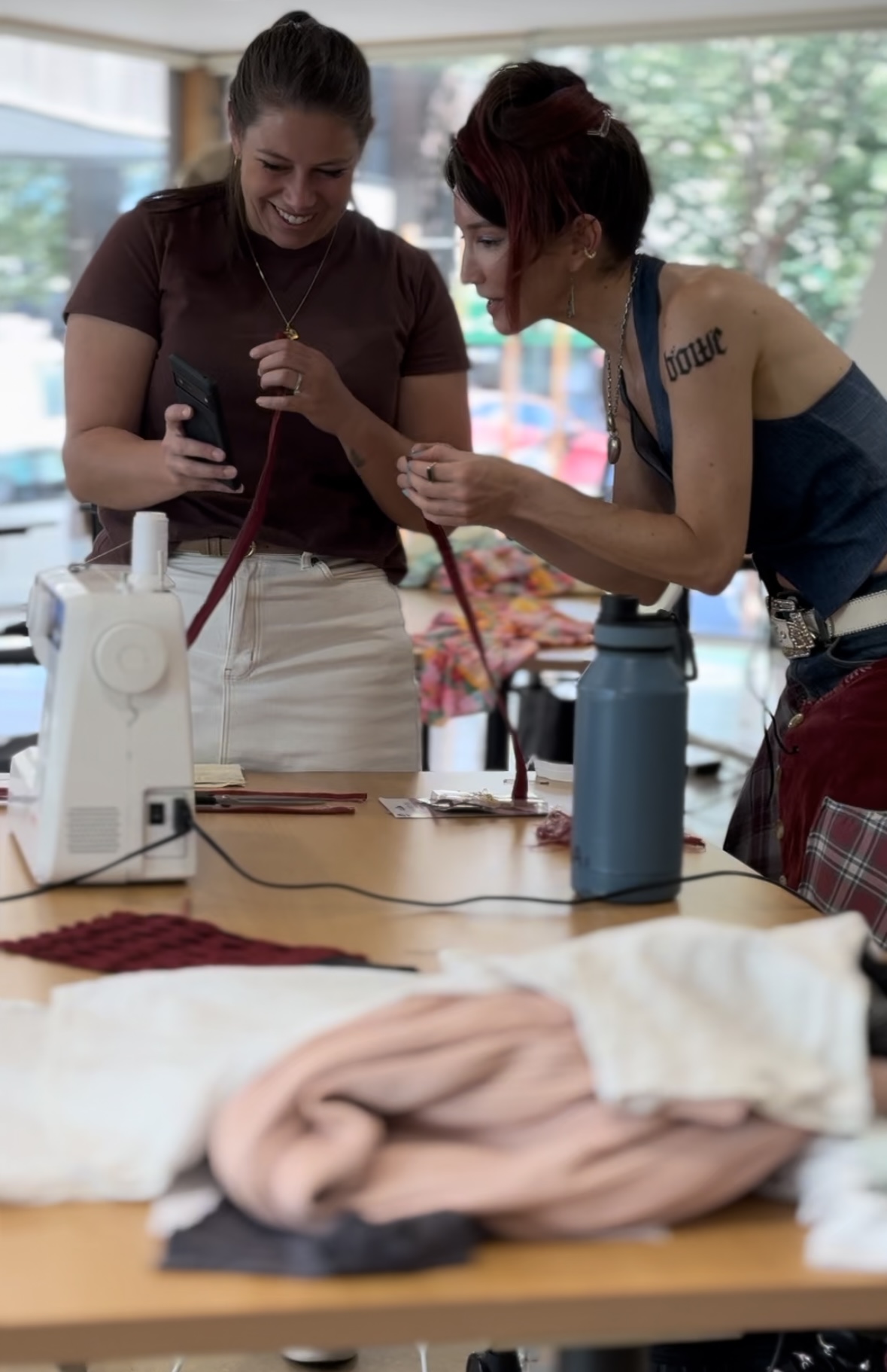 Two workshop participants examining a piece together
