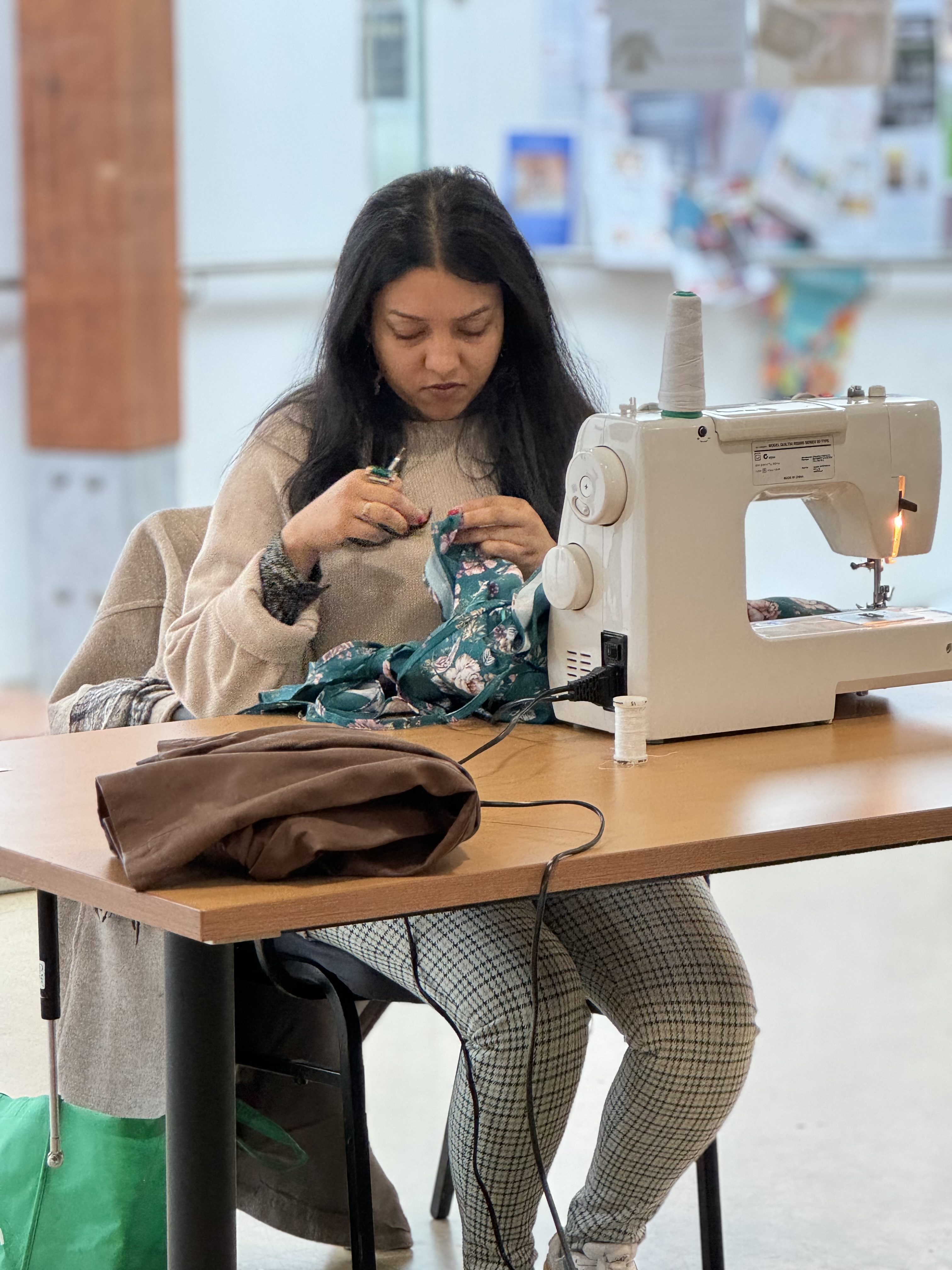 Workshop participant sewing floral fabric